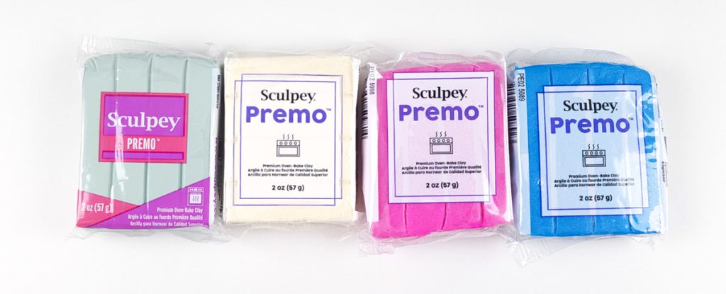 Packages of Sculpey Premo showing the old packaging and the new.
