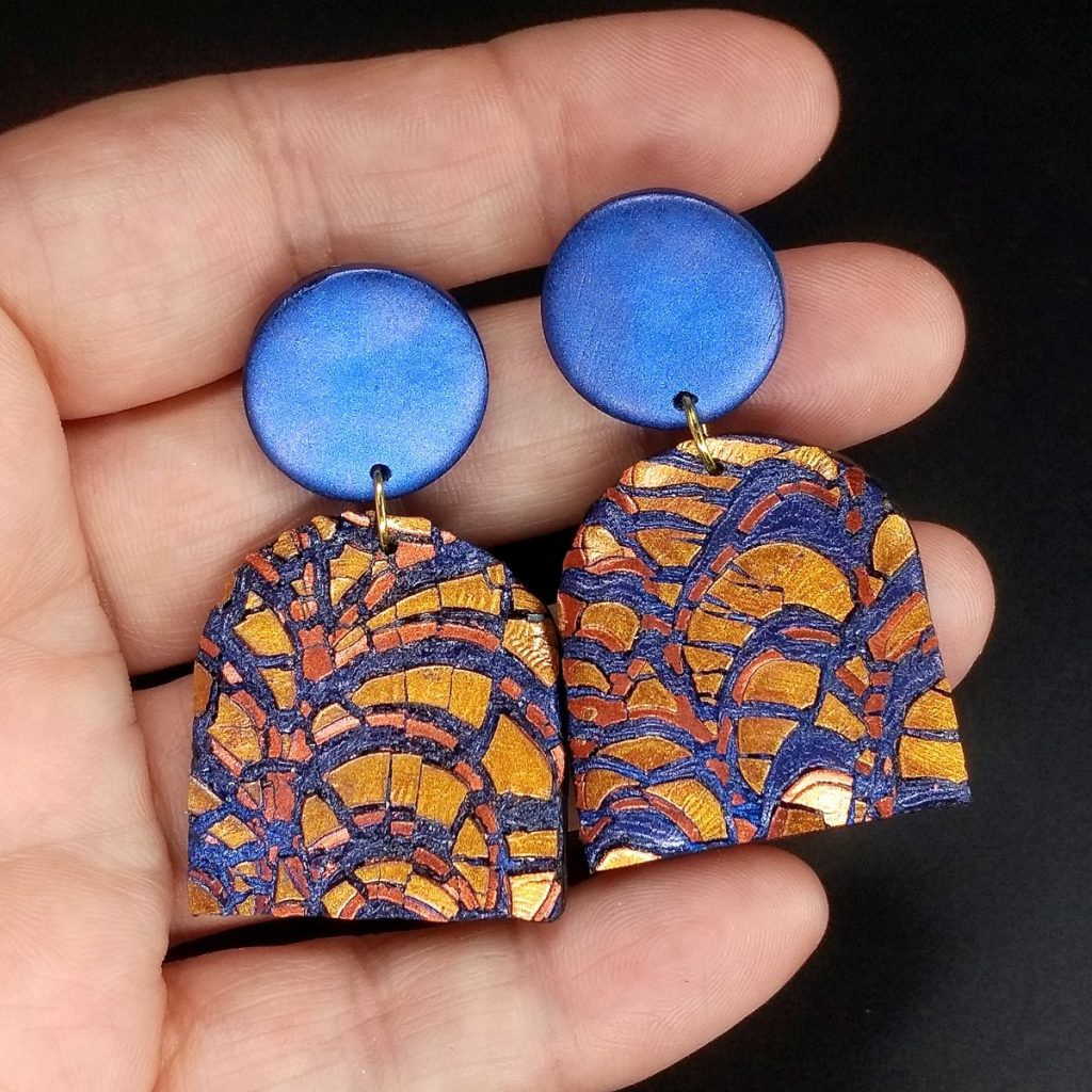 Polymer clay earrings made with pearl ex and a crackle effect.