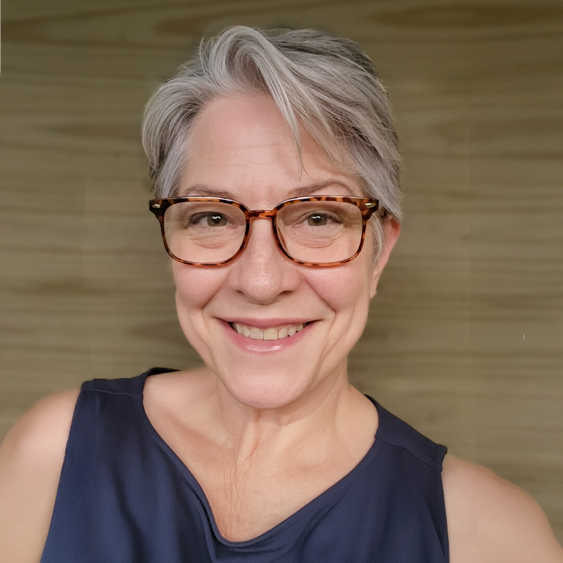 Photo of woman with short gray hair, glasses, wearing a navy blue tank top.