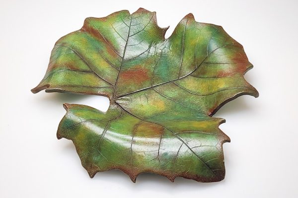 Leaf bowl made with green polymer clay and then colored and shaded with multiple colors of pastels.
