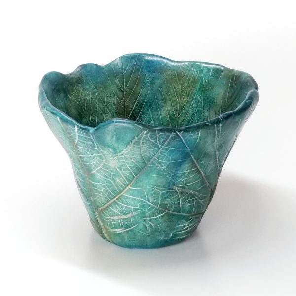 Leaf-textured green pinch pot made from polymer clay and colored with pastels.