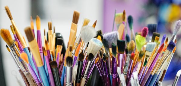 An array of paintbrushes in a polymer clay studio.