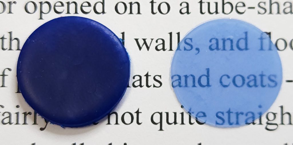 Circles of Cernit Translucent Blueberry, both #7 thickness, comparing the intensely dark full strength with the still quite blue 1/64 dilution.