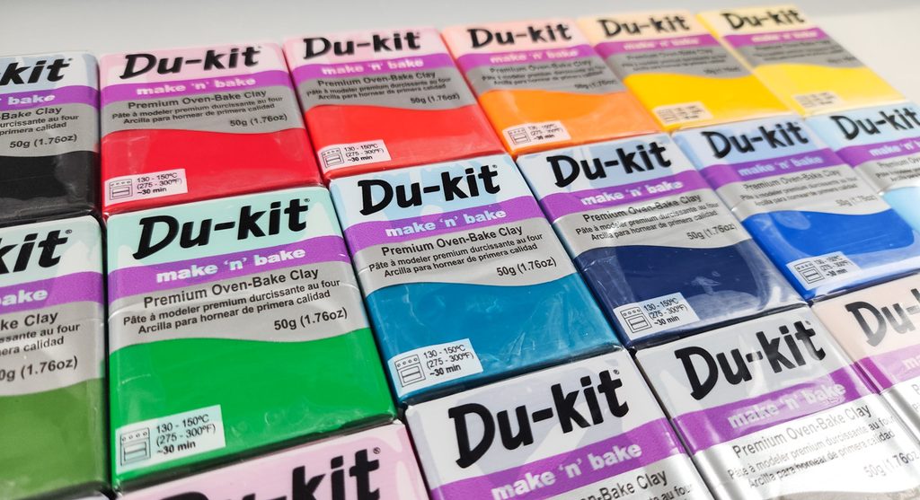 Packages of Du-kit polymer clay in bright colors.